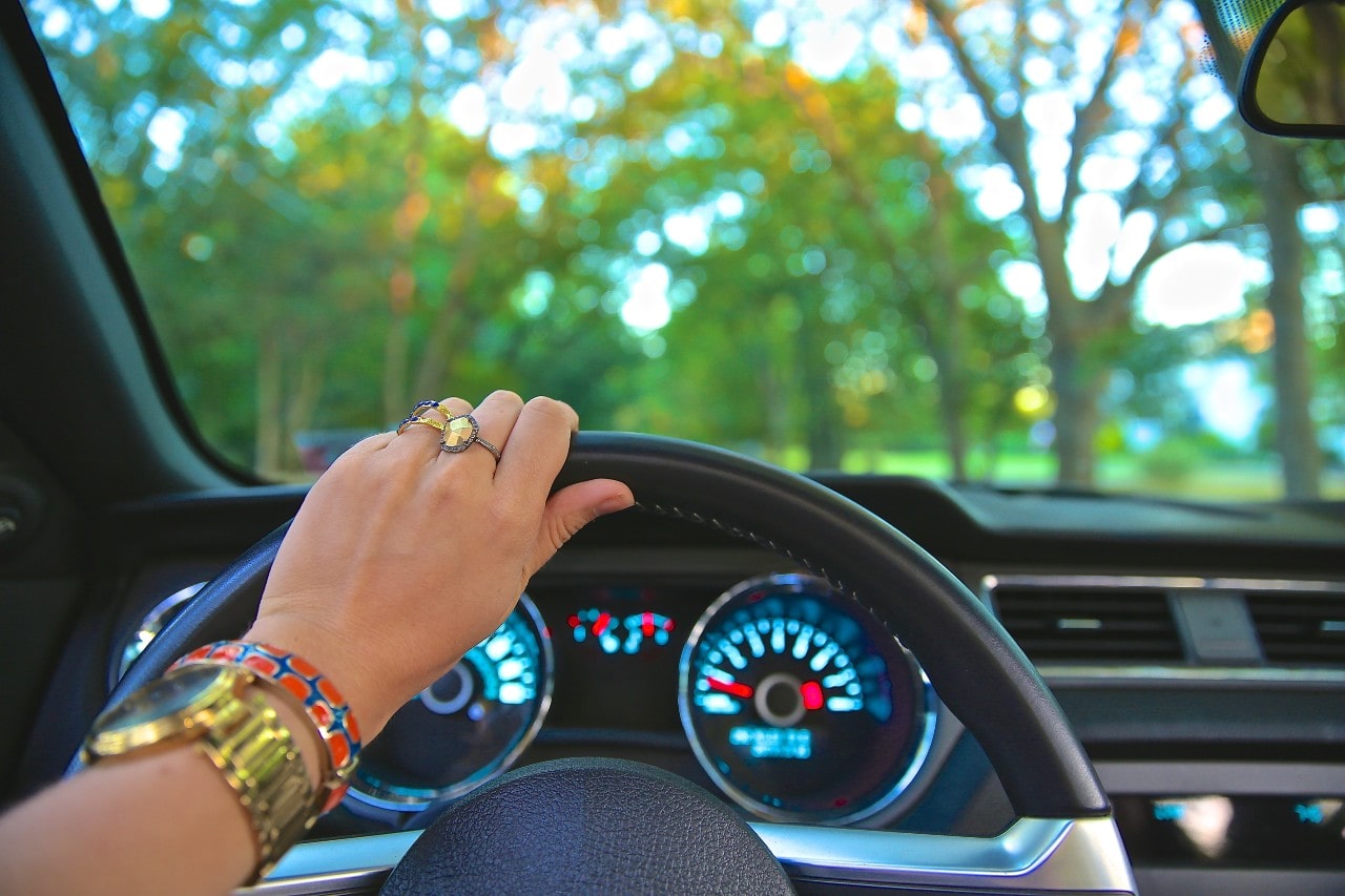  Woman driving whilst wearing a yellow garnet ring