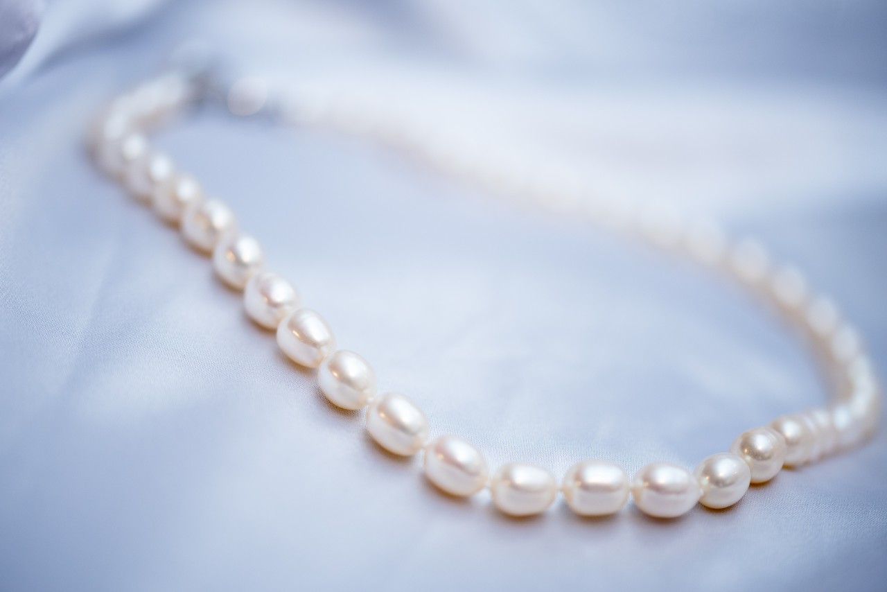 Radiant pearl necklace sitting on a textile surface
