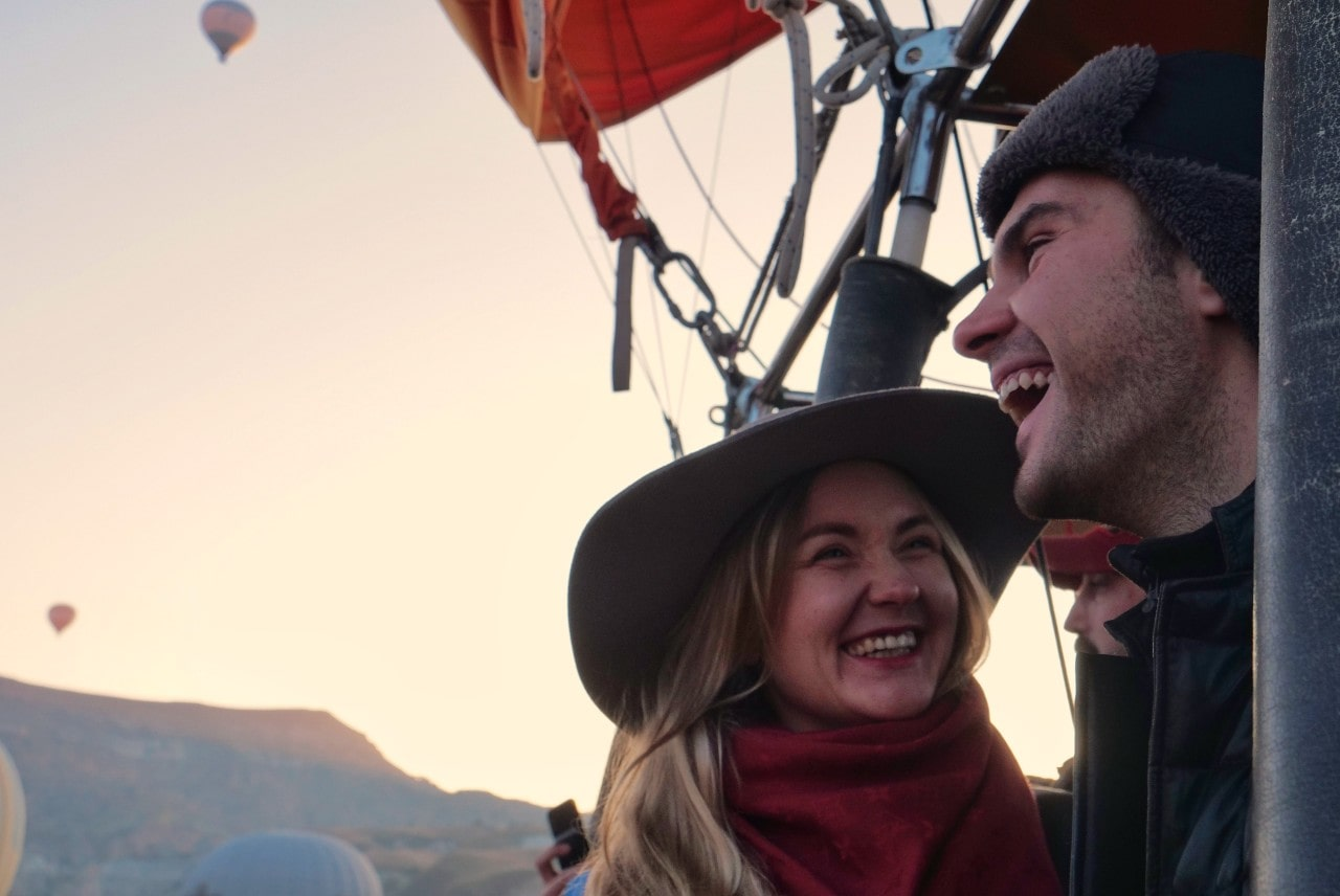 A couple participates in a hot air balloon ride as a date night