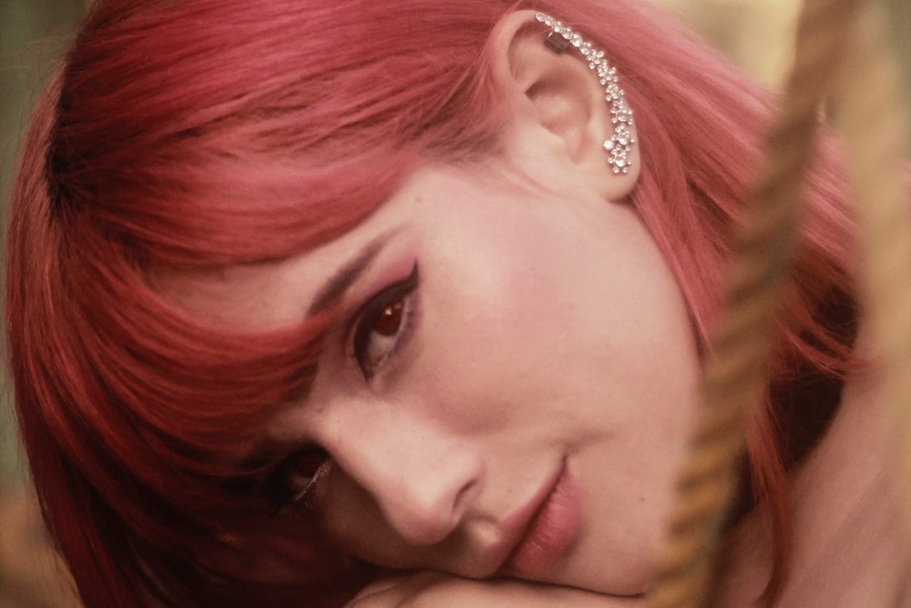 A close-up of a fashionable young woman wearing a distinctive diamond ear cuff up her entire left ear.