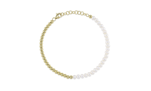 An elegant Shy Creation pearl and gold bracelet, available at Aucoin Hart Jewelers.