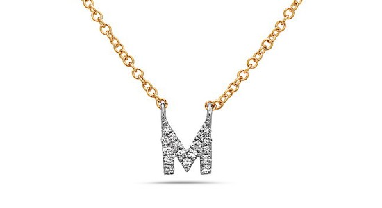 a mixed metal necklace featuring an “M” pendant