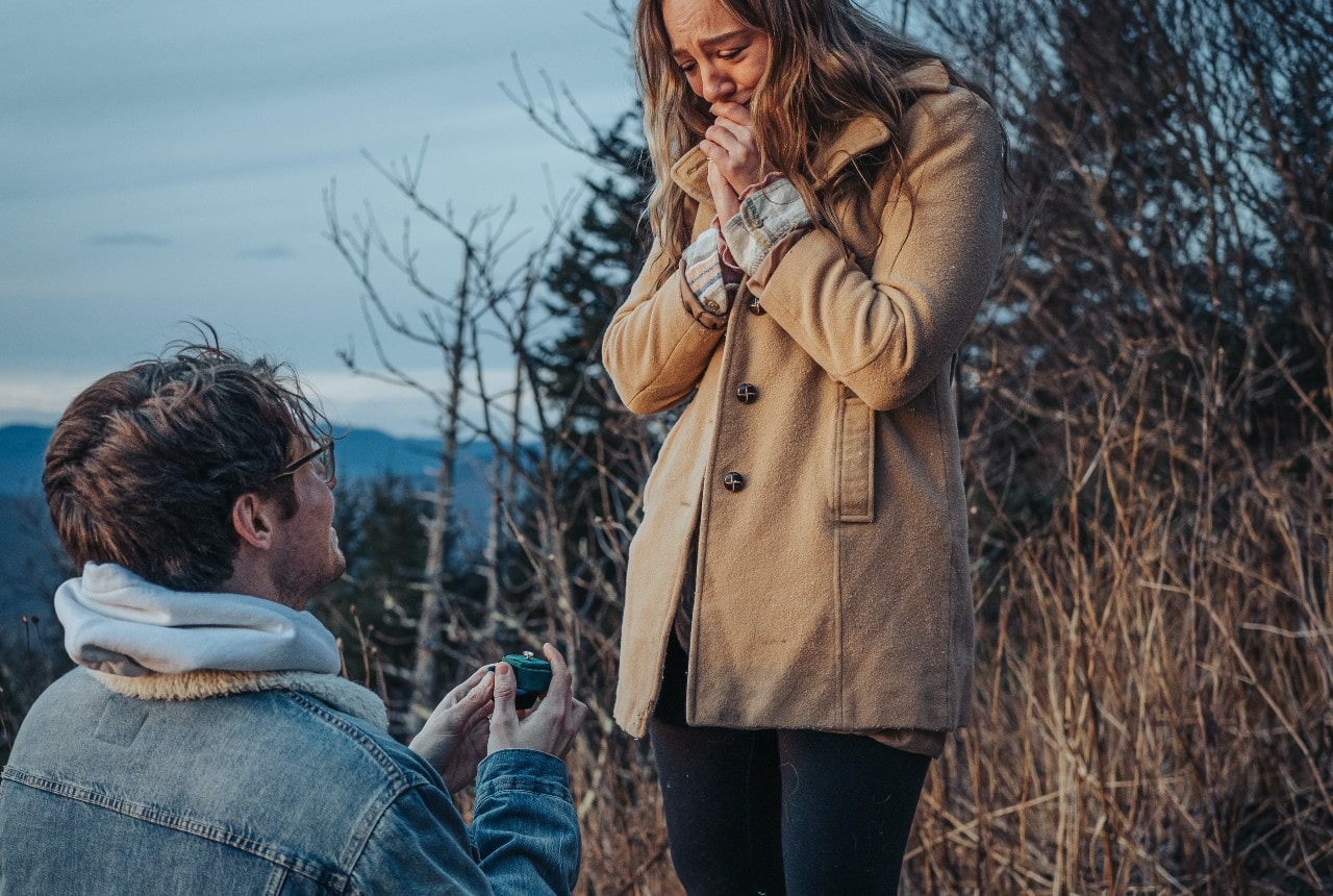 man proposing to woman with engagement ring from Aucoin Hart Jewelers