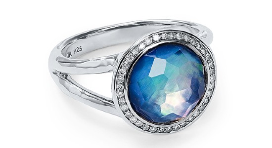 a white gold fashion ring with a blue center stone