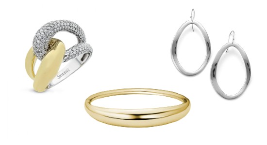 a mixed metal fashion ring, a gold bangle, and a pair of silver earrings