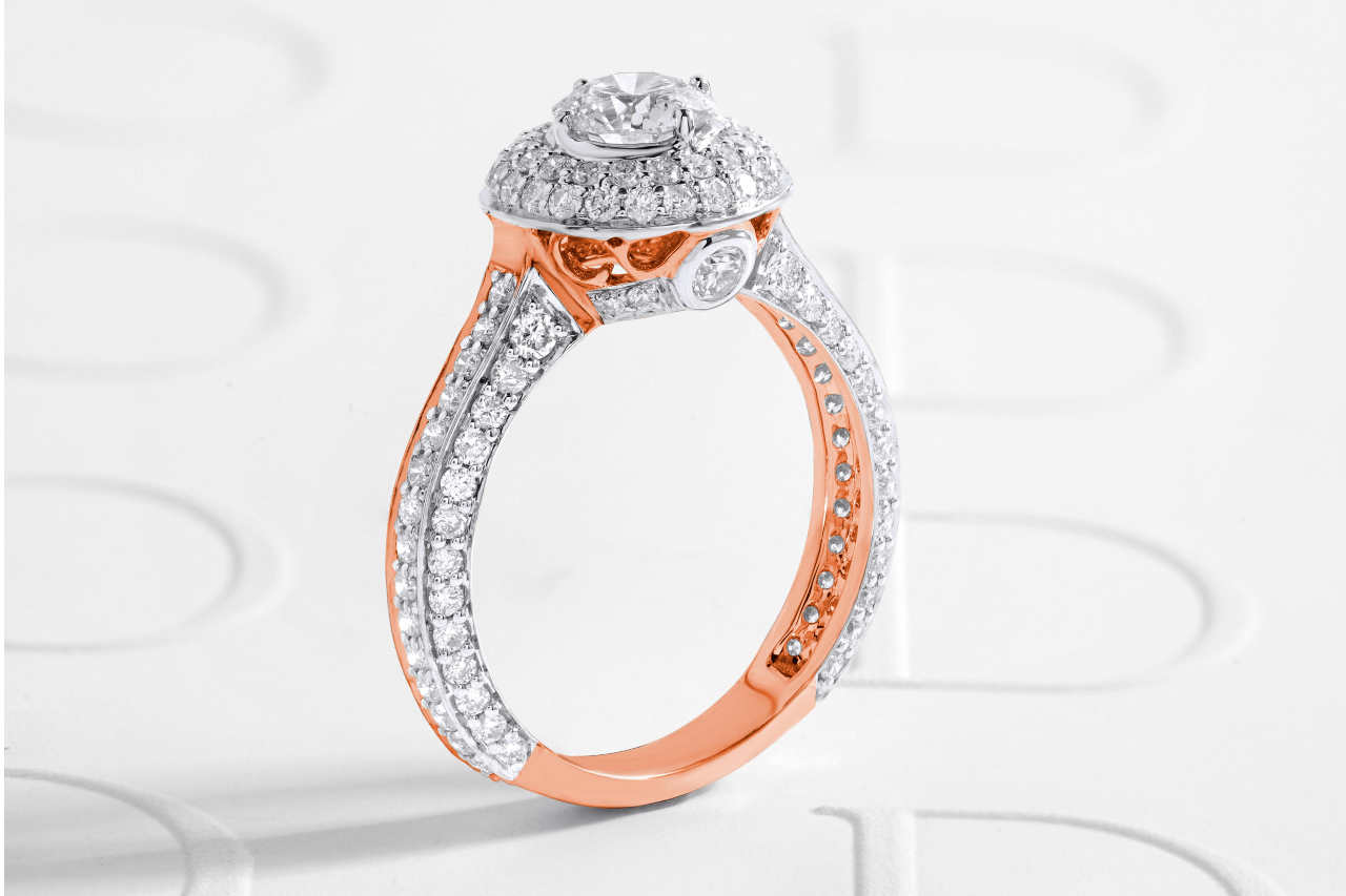 a rose gold and diamond engagement ring on a white background